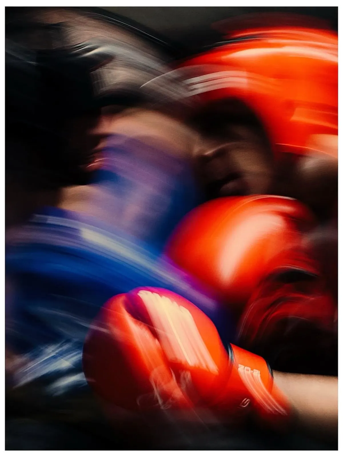 Long-exposure blur of red gloves mid-exchange.